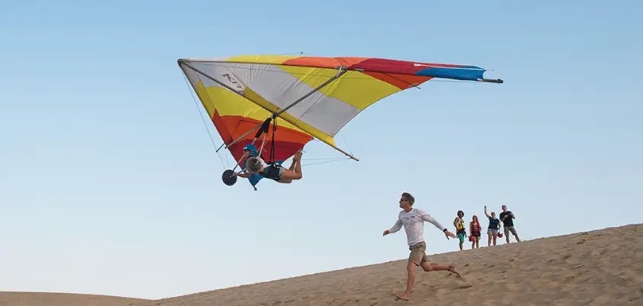 Learning to hang glide at the beach