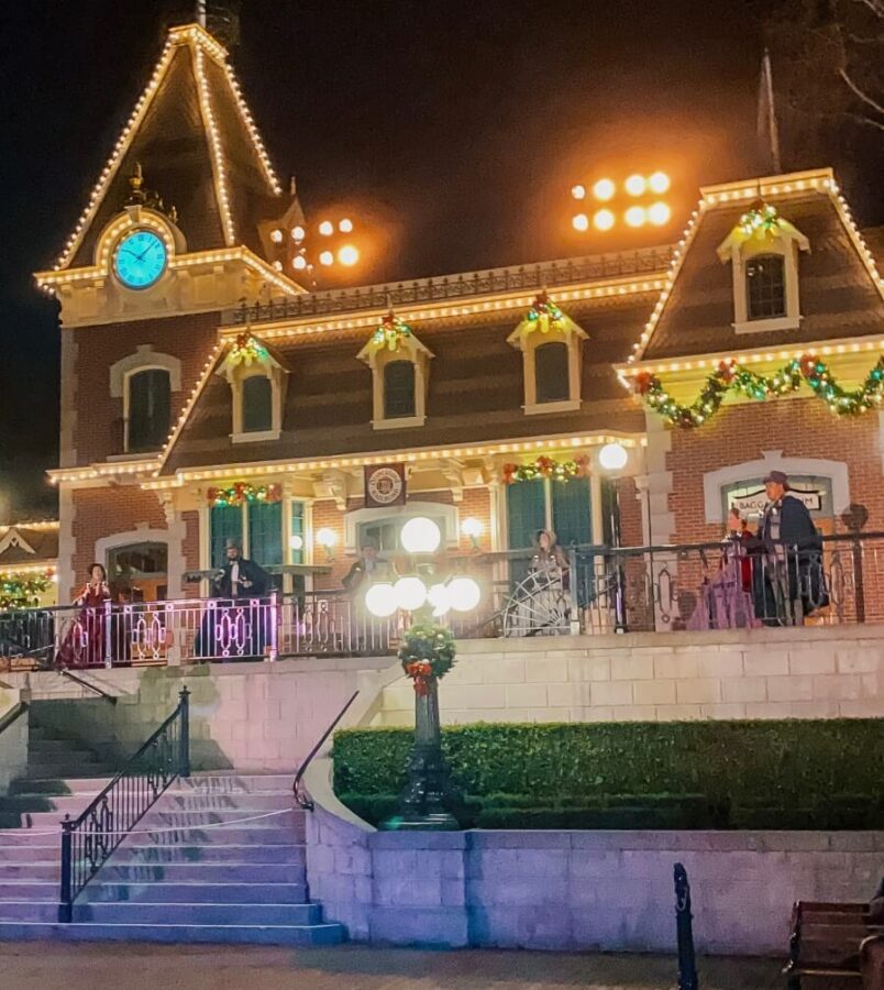 Dickens Carolers performing the Train station set at the Train Station in Disneyland 