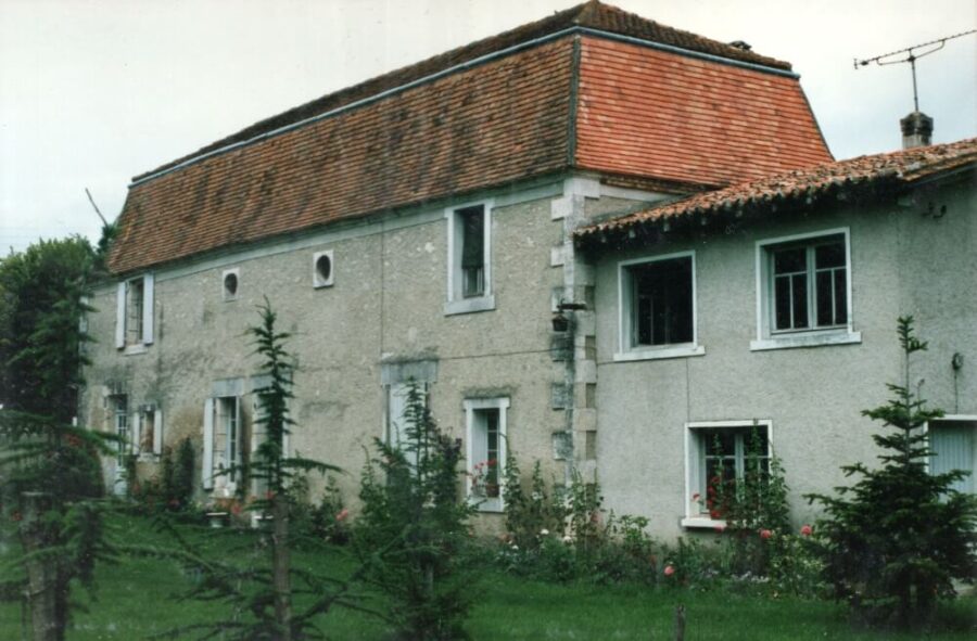 The full facade of the stone manor house in Pallaud