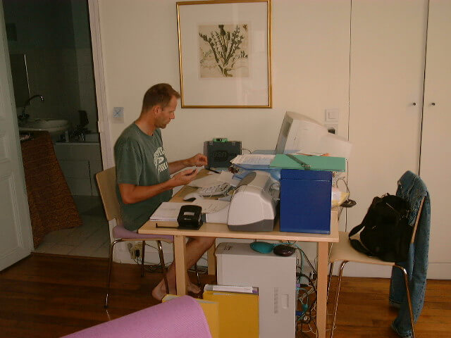 Schuyler Hoffman working at his desk (dining room table) in Schuyler Hoffman's apartment in Paris