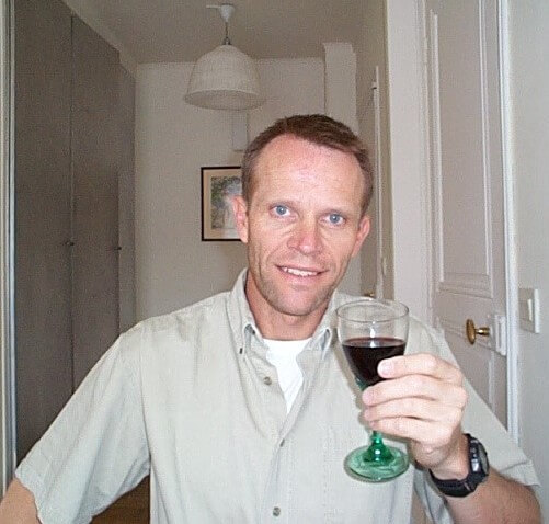 Schuyler Hoffman having a glass of wine in his apartment in Paris