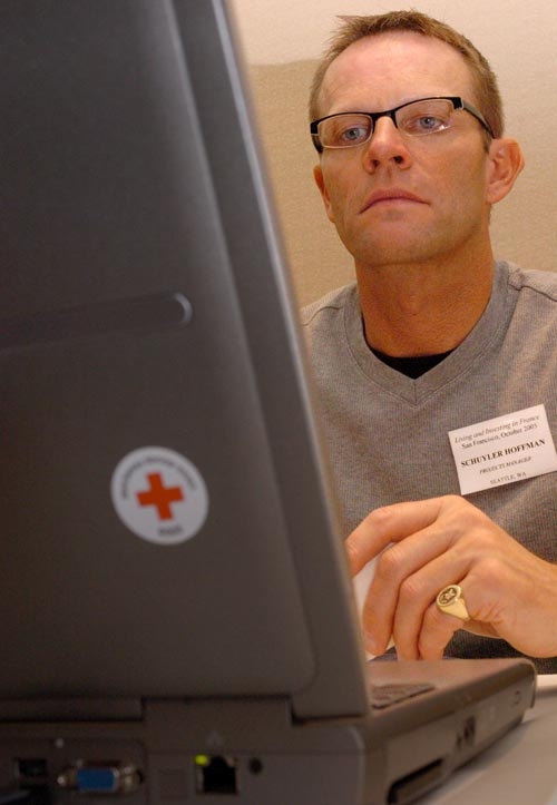 Schuyler Hoffman at his laptop while managing a Living and Investing in France conference in San Francisco in 2005